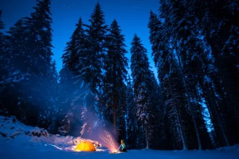 Winter camping with fire at night Stock Photos