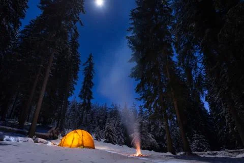 Winter camping with fire at night Stock Photos
