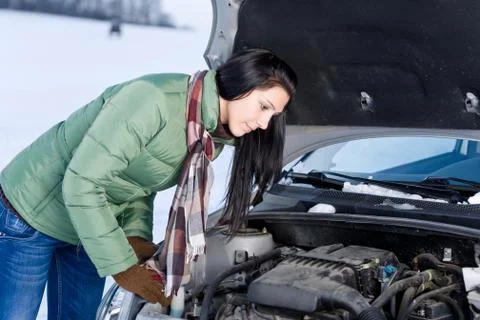 Winter car breakdown - woman repair motor Stock Photos