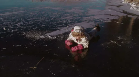 Winter. Children playing on frozen lake. Stockbeeldmateriaal 59726049