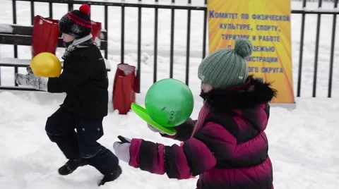 Winter Children sports program - boy And Girl Running with balls Stock Footage 59115907