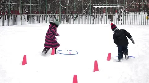 Winter Children sports program - boy and girl who run faster Stock Footage 59116438