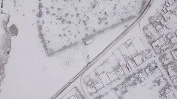 Winter city, aerial camera, the camera flies over the snow-covered city in Stock Footage 85560422