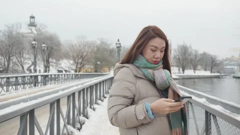 Winter City Stroll with Smartphone Stock Footage 327082673