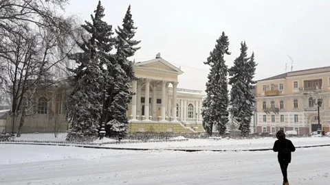 Winter in classical part of city. Man in a hood and mask Stock Footage 143332029