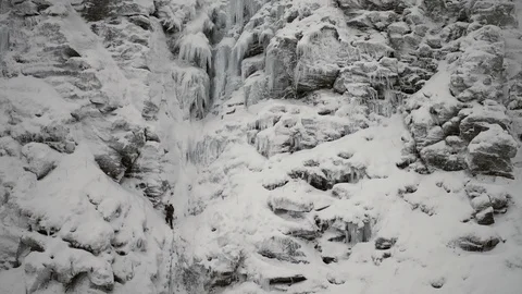 Winter climber on ice/rock face. Drone shot. 4K Stock Footage 90122317