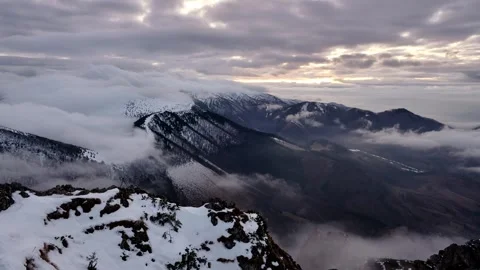 Winter Cloud Inversion Timelapse over Snowy Mountain Ridges Stock Footage 327594545