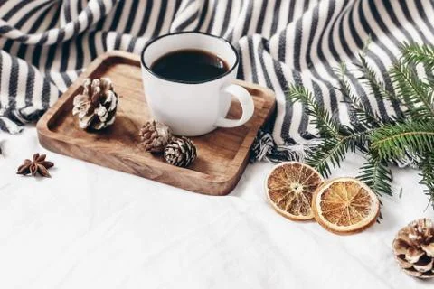 Winter composition. Breakfast in bed. Cup of coffee on wooden tray, wool blanket Stock-Fotos