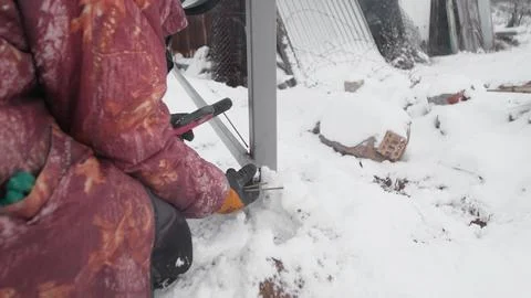 Winter Construction Activity Amid Challenging Snowy Conditions and Harsh Weather Stock Photos