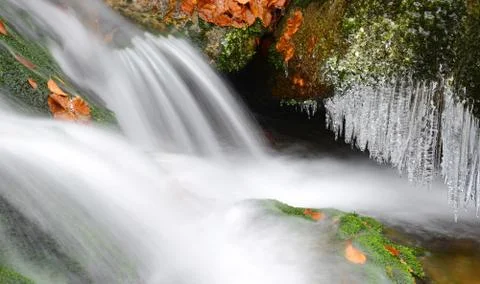 Winter creek with icicles Stock Photos