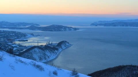 Winter dawn over a snowy bay and city port Stock Footage 337033316