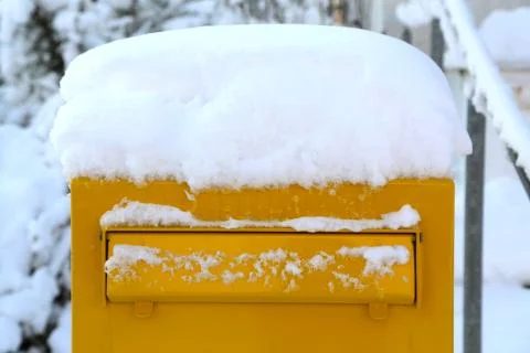 Winter day, snow covered post box. Stock Photos