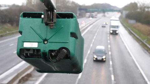 Winter day view average speed traffic camera under falling snow over UK Motorway Stock-Fotos