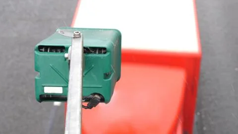 Winter day view average speed traffic camera under falling snow over UK Motorway 库存照片