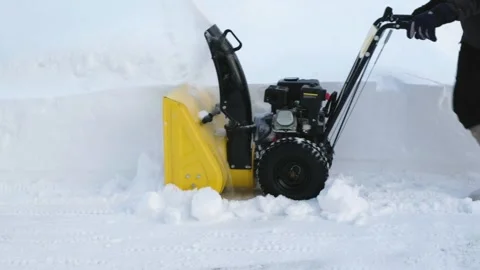 In winter day in the yard after a heavy snowfall man cleans the path of a house  Stock Footage 262457609