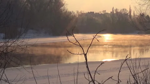 Winter Desna River, sunset, snow, bushes, steam on the water, nature of Ukraine. 스톡 동영상 326896907