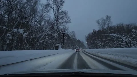 Winter driving exiting right curve into straight forest road following car Video stock 333091613