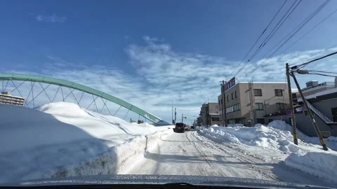 Winter driving to intersection with traffic light Sapporo POV Video stock 333204750