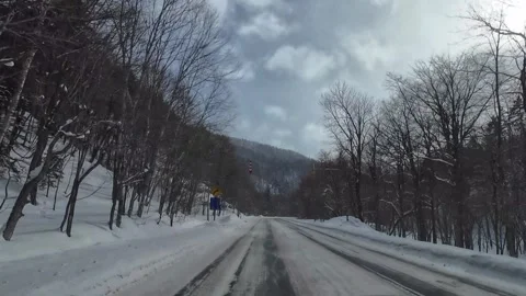 Winter Driving on Snow-Covered Mountain Road in Furano, Hokkaido, Japan Video stock 333586779