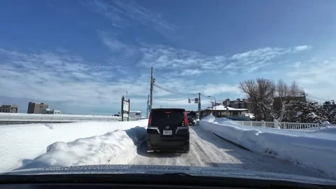 Winter driving stopped red light narrow snowy road oncoming cars Video stock 333204778