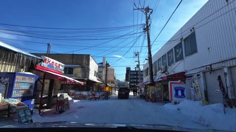 Winter driving through Hakodate fish market area with shops and cars Video stock 333069470