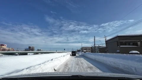Winter driving toward red light snowplow tractor passing snowy road Video stock 333204775