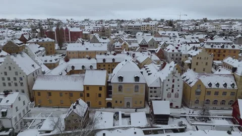 Winter Drone Flight Across Visby Old Town Cityscape in Snow Stock Footage 330023015