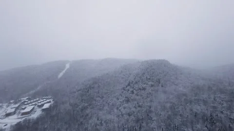 Winter drone glide above snow-covered mountain slopes Stock Footage 321251784