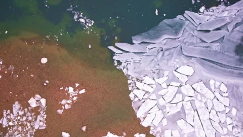 Winter drone shot of beautiful ice patterns covering the surface of a northern Stock Footage 338197272