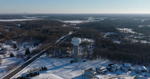 Winter Drone Shot Flying Towards A Water Tower In Dayton Minnesota Pineview LN Stock Footage 228894078