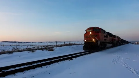 Winter dusk loaded coal train approaches from left to right with horn toot Stock Footage 105190695