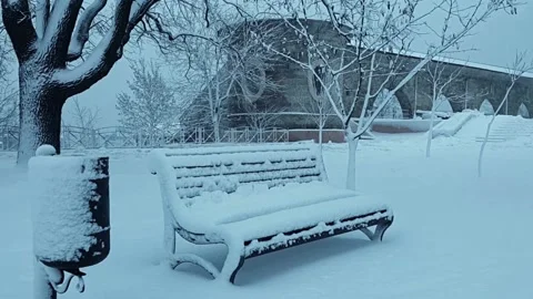 Winter evening in city park. The tower, arcade and bench are visible. Stock Footage