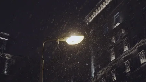 Winter evening scene. Falling snow illuminated by a streetlamp Stock Footage 103939225