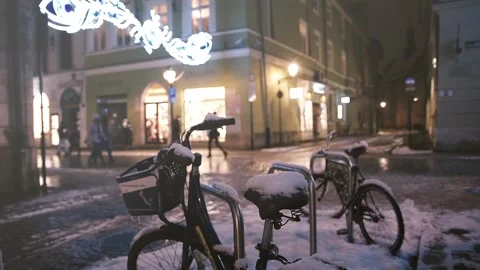 Winter evening view of bicycles standing on illuminated street of historic city. Stock Footage 148498454