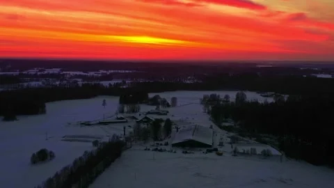 Winter evening with vivid orange sunset sky over snow covered land and isolated 動画素材 334103835