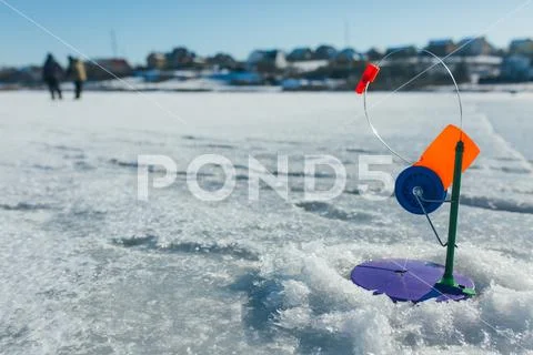 Winter fishing, fishing rod stands on the hole waiting for the