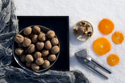Winter flat lay with  walnut on black tray,   cracked nut with nutshell, Nutc Stock Photos