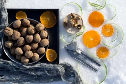 Winter flat lay with  walnut on black tray,   cracked nut with nutshell, Nutc Stock Photos