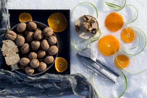 Winter flat lay with  walnut on black tray,   cracked nut with nutshell, Nutc Stock Photos