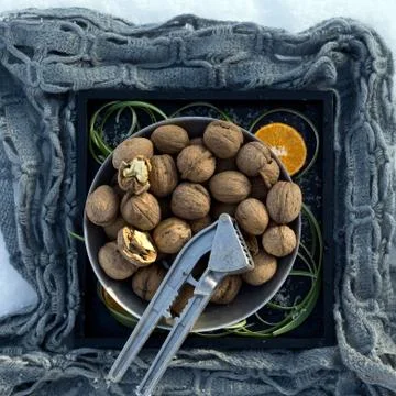 Winter flat lay with  walnut,   Nutcracker on black tray on  background Stock Photos