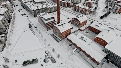 Winter flight over the frozen harbor and old factory building in Lahti. Stock Footage 257614357