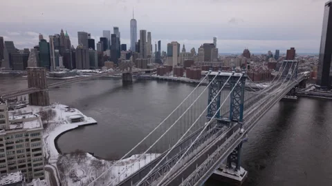 Winter flying counter clockwise around Manhattan Bridge view of downtown NYC Stock Footage 329533255