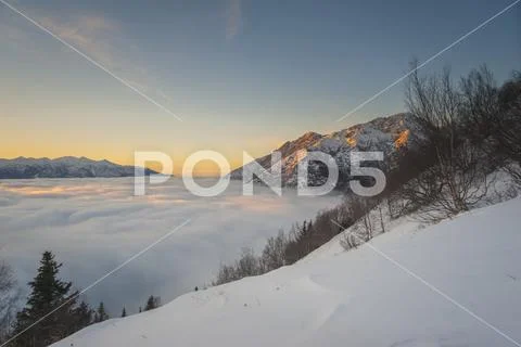 Winter fog flowing into the Cook Inlet as seen from the Bird Ridge Trail in Sout Stock Photos