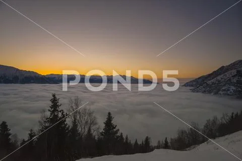 Winter fog flowing into the Cook Inlet as seen from the Bird Ridge Trail in Sout Stock Photos