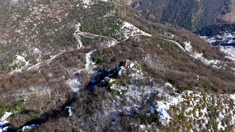 Winter Forest Drone Flight Descending from Snowy Mountain Ridge in 4K 60fps Stock Footage 334677496