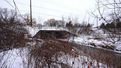 Winter Forest Landscape with Stream Running Through Snow at Courtice Park 動画素材 334257634