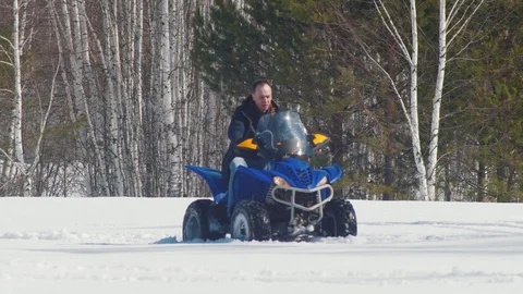 A winter forest. A man riding a big snowmobile Stock Footage 106880864