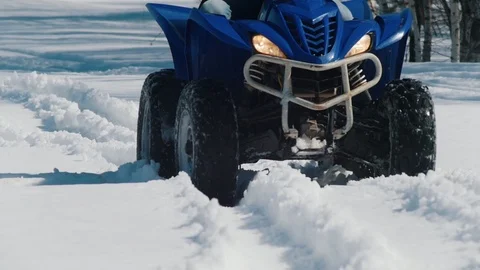 A winter forest. A person riding a big blue snowmobile Stock Footage 106876351