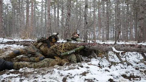 Winter forest. Soldier reported the situation by radio, takes MANPADS and aims Stock Footage 127629085