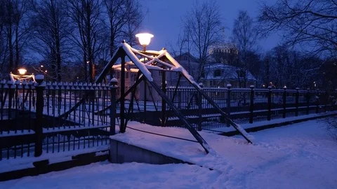 Winter frosty night view diagonally to the metal bridge over the canal. Stock Footage